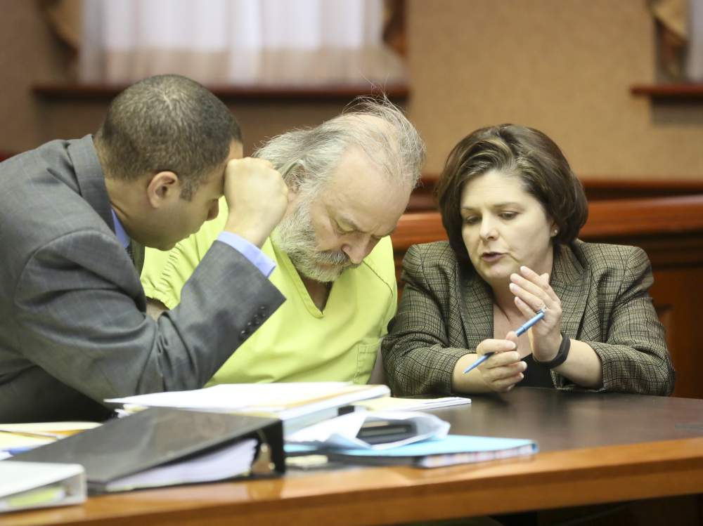 Defense attorneys Lawrence Hawkins and Melynda Cook consult with Daniel French