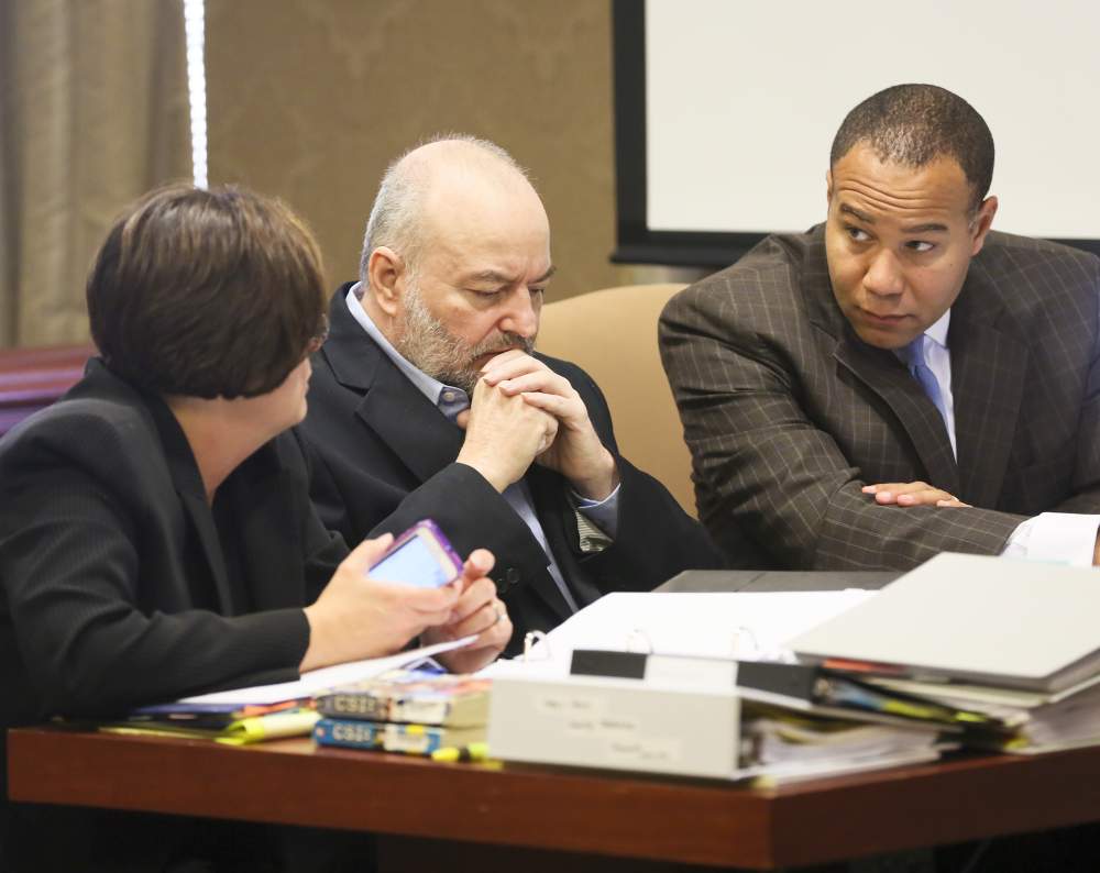 Defense attorneys Melynda Cook and Lawrence talk with Daniel French during trail