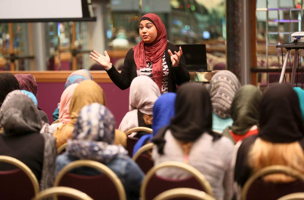 Umama Alam talks to students from Mother of Mercy High School inside the education center of the Islamic Center of Greater Cincinnati during a tour of the campus Wednesday, Nov. 4, 2015.